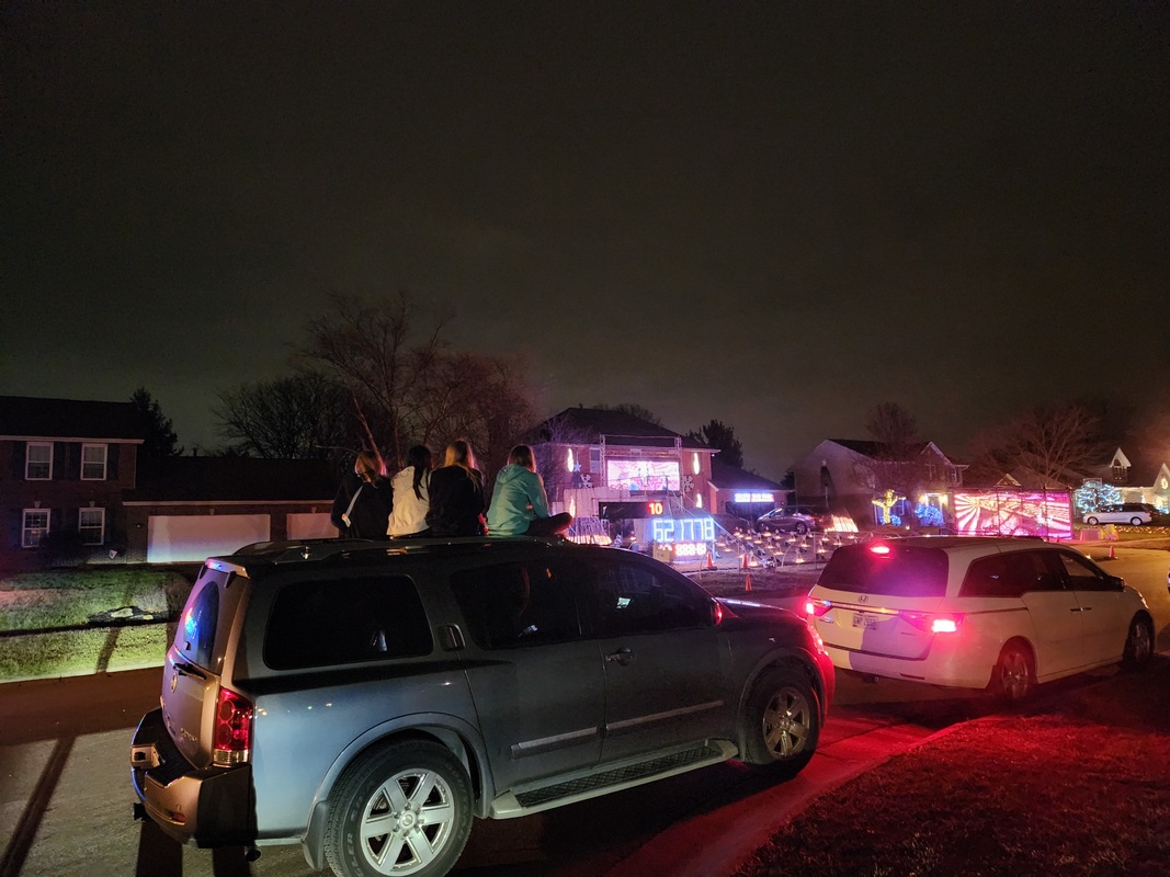 Visitors sitting on their SUV watching the show - Dec 17, 2022