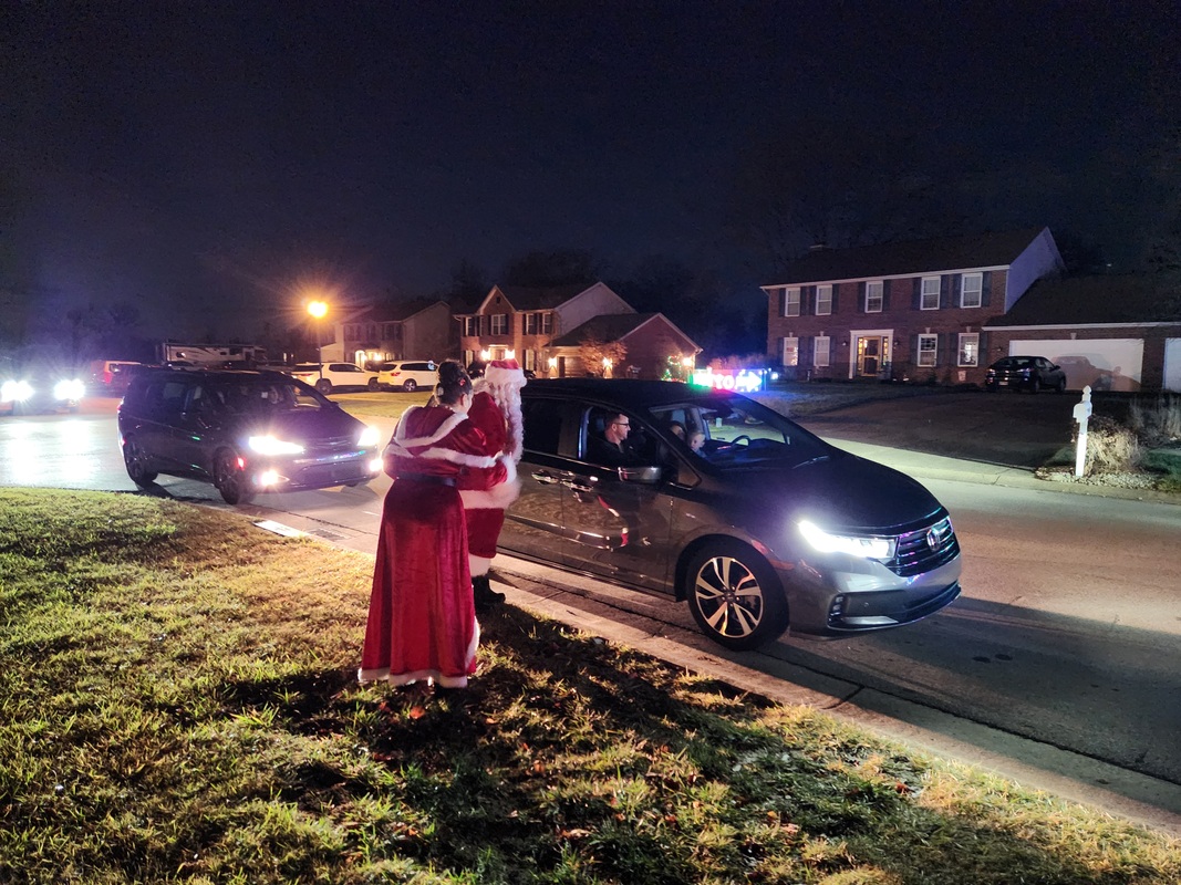 Mrs. Claus waving to passing cars - Dec 24, 2023